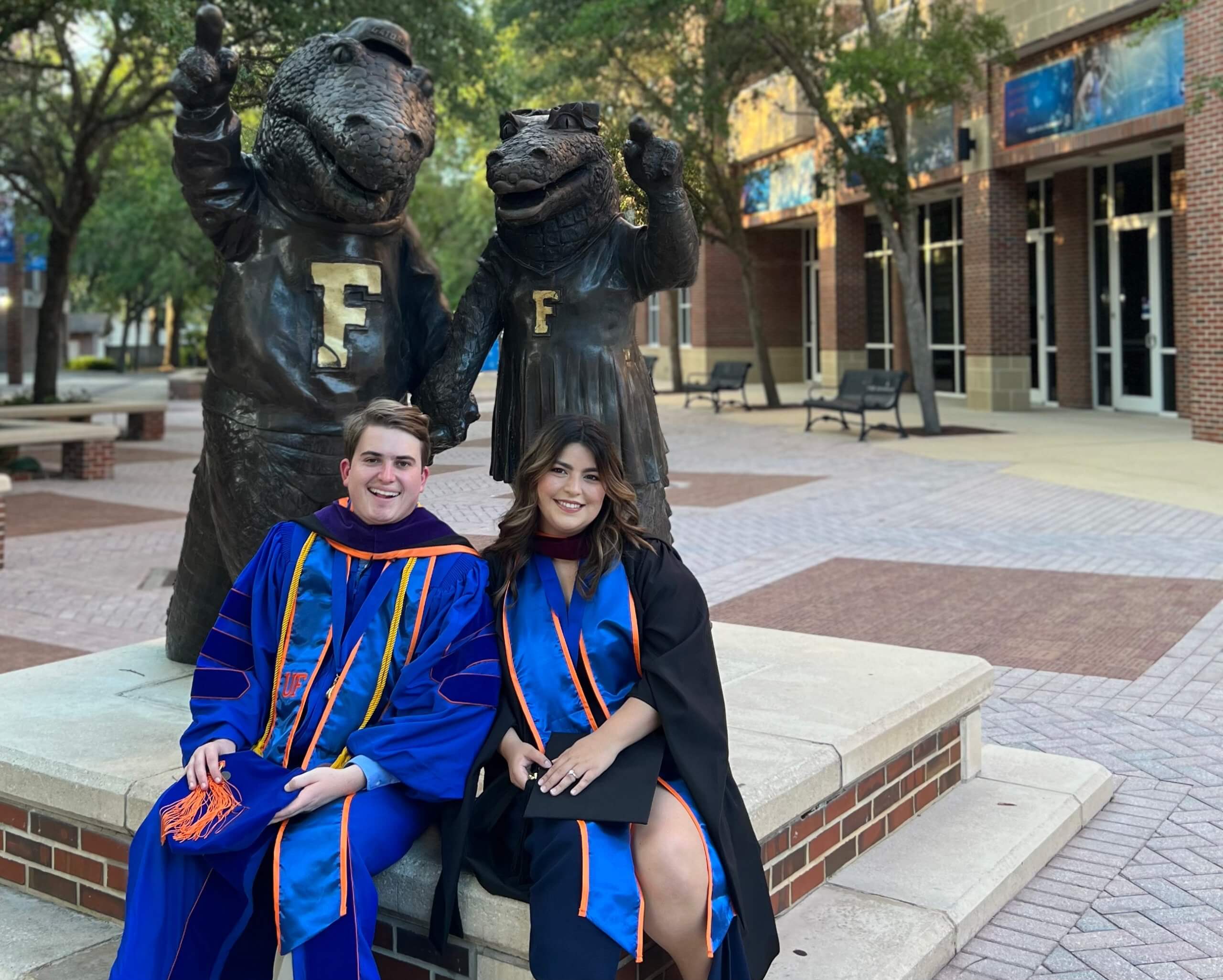 Kelsey and Husband in grad cap and gowns at UF